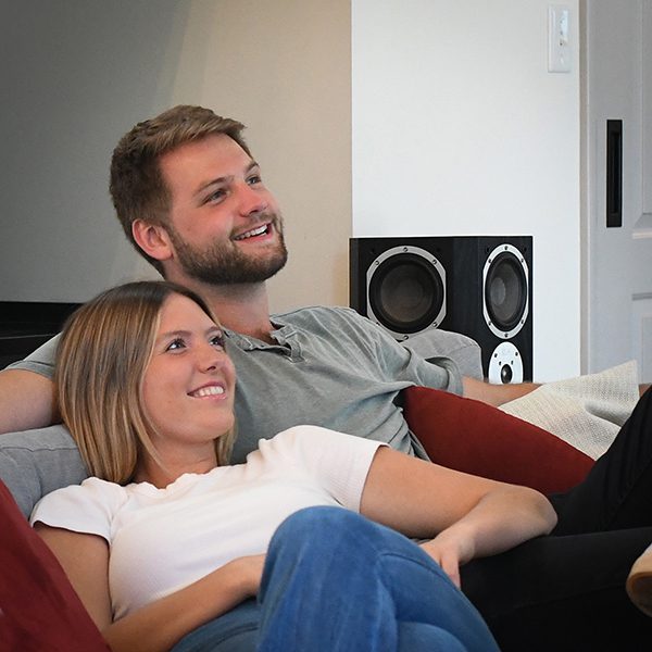 Beacons Surround sound speakers behind couple